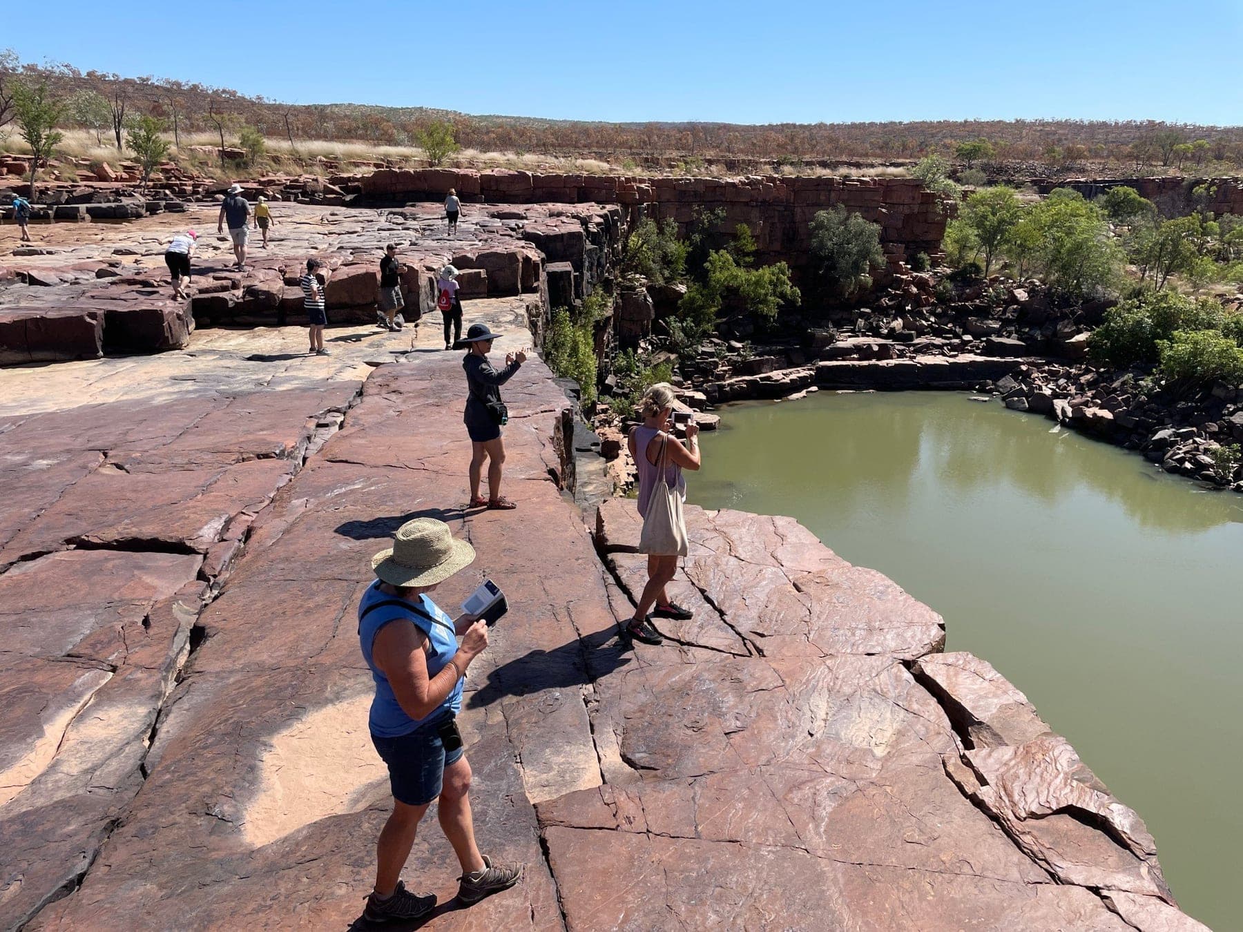 Bindoola Falls dropping over a red rock escarpment
