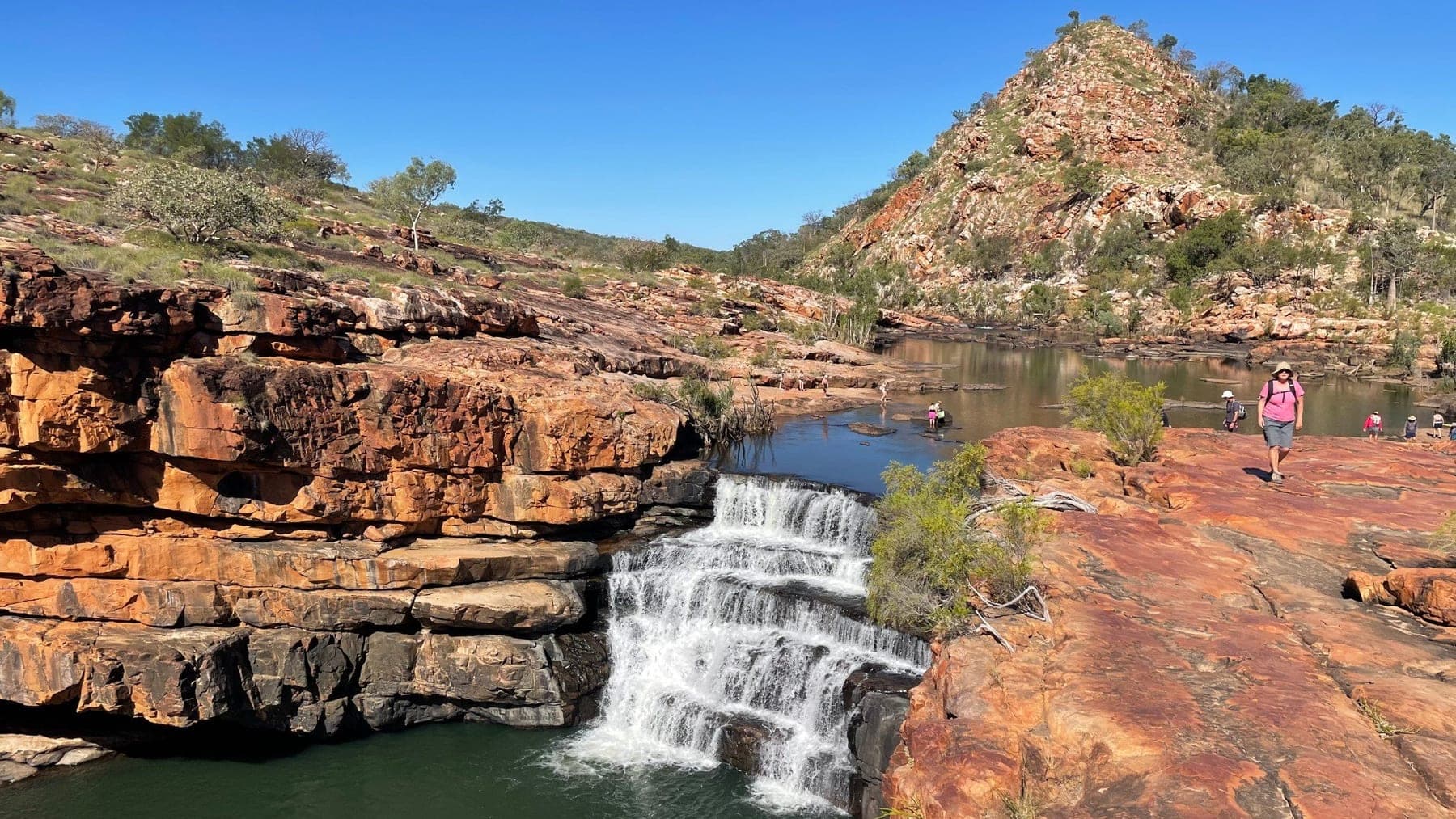 A guest looking out over the Bell Gorge waterfall in the Kimberley