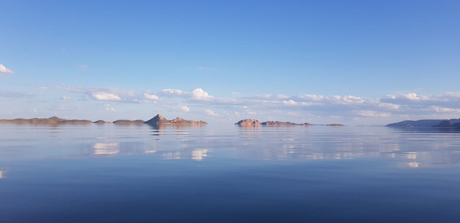 The blue expanse of Lake Argyle ringed by red ranges